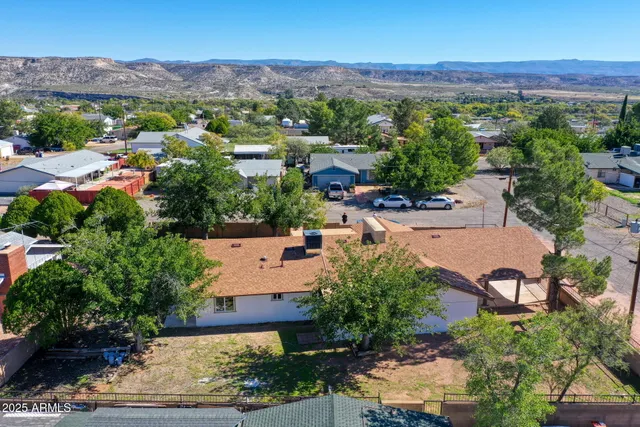 an aerial view of a house with a yard and garden