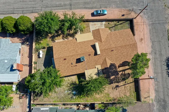 an aerial view of a city with lots of residential buildings and mountain view in back
