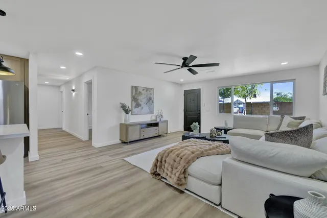 a living room with furniture and a wooden floor