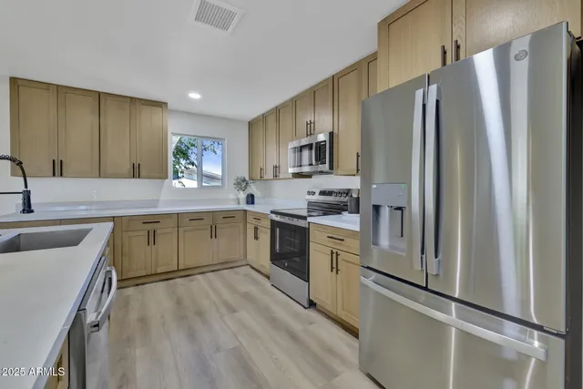 a kitchen with a refrigerator sink and stove