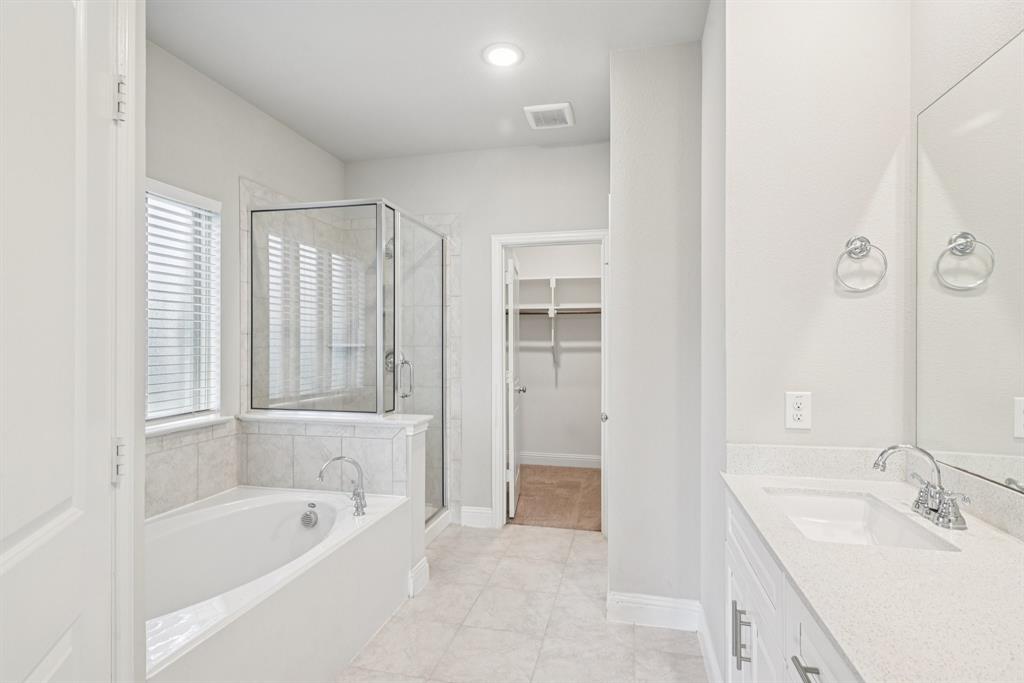 2321 Mount Olive Lane Forney, TX 75126 - Photo 18 of 35 Full bathroom featuring a shower stall, a garden tub, vanity, a walk in closet, and tile patterned flooring
