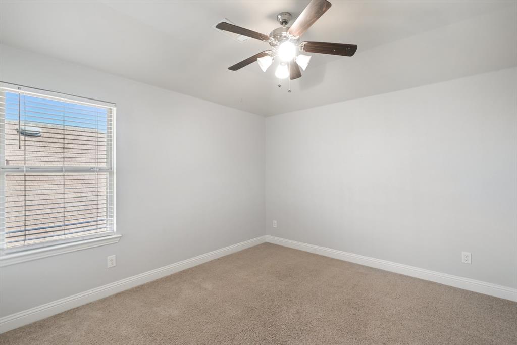 2321 Mount Olive Lane Forney, TX 75126 - Photo 26 of 35 Carpeted empty room featuring ceiling fan and baseboards