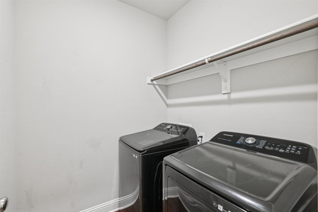 2321 Mount Olive Lane Forney, TX 75126 - Photo 31 of 35 Laundry room with washing machine and dryer and wood finished floors