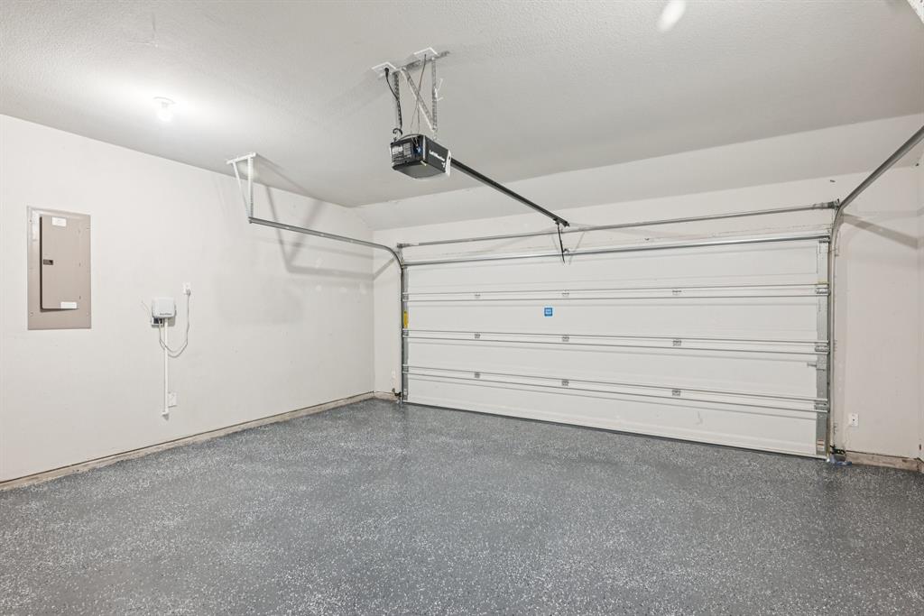 2321 Mount Olive Lane Forney, TX 75126 - Photo 32 of 35 Garage with electric panel and a garage door opener