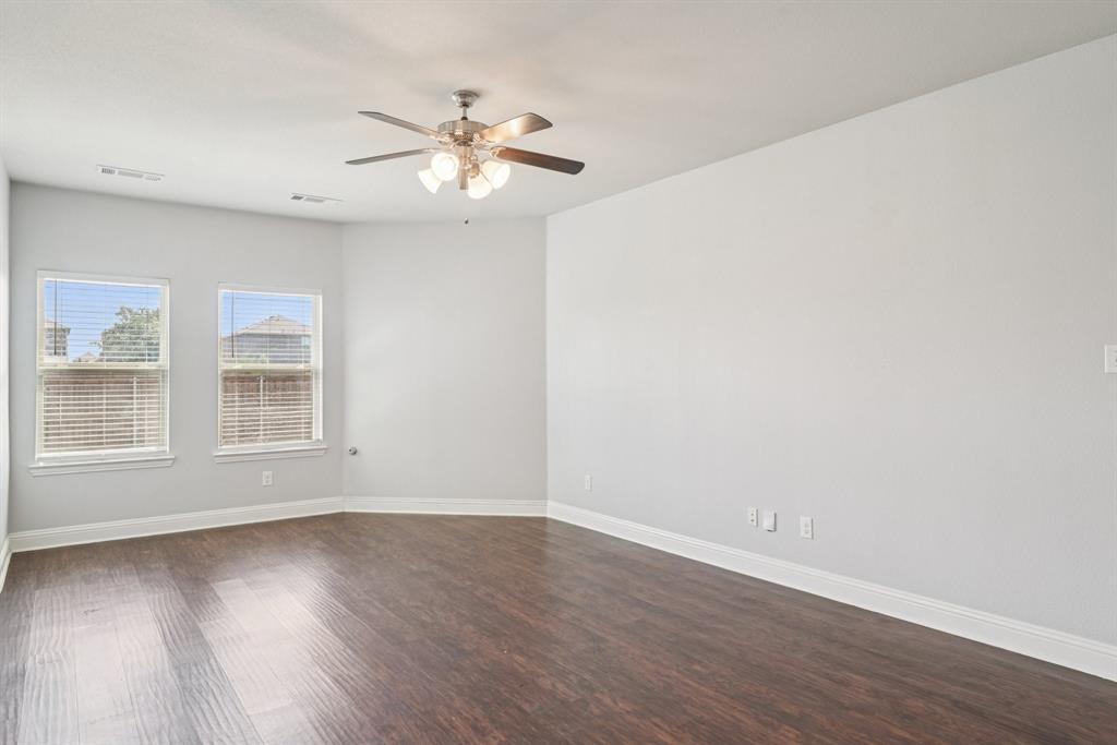 2321 Mount Olive Lane Forney, TX 75126 - Photo 8 of 35 Unfurnished room featuring dark wood finished floors and a ceiling fan