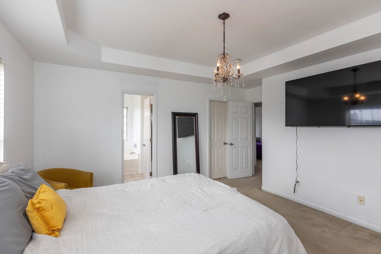 3409 Colossae Court Raleigh, NC 27610 - Photo 17 of 28 a bedroom with a bed and a flat screen tv