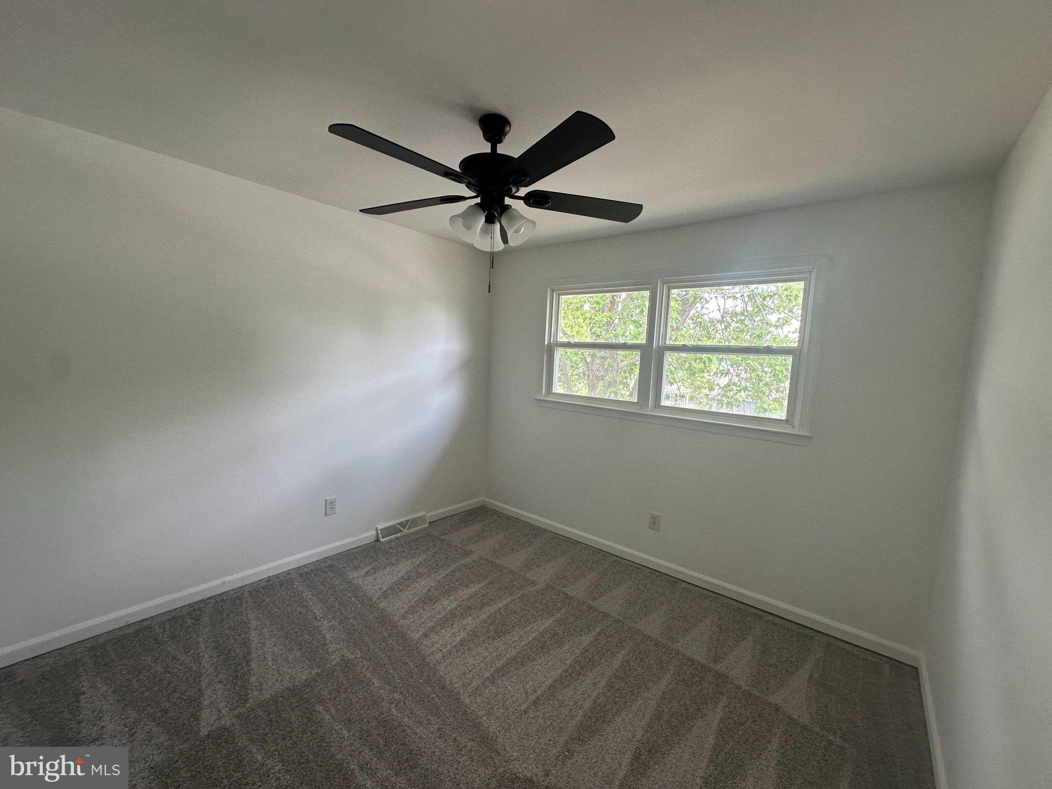 6 Travertine Way Newark, DE 19702 - Photo 19 of 22 an empty room with a window and a fan