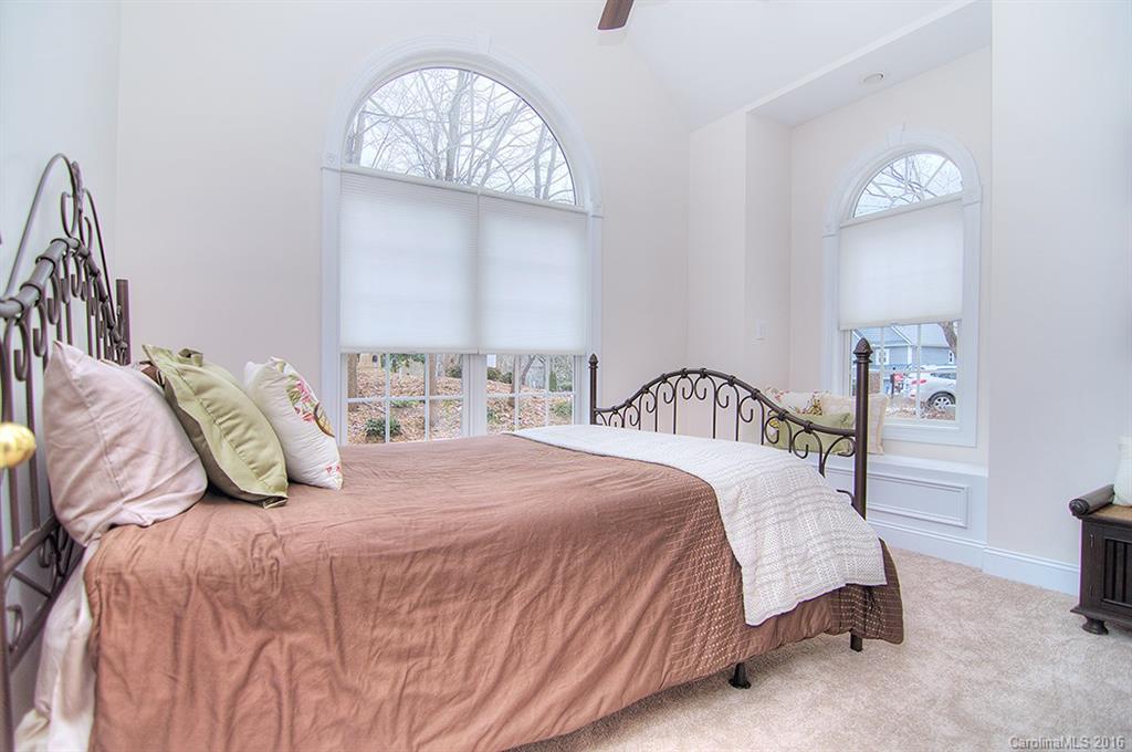 29023 Beaver Run Tega Cay, SC 29708 - Photo 11 of 24 a bedroom with a bed and a table in it