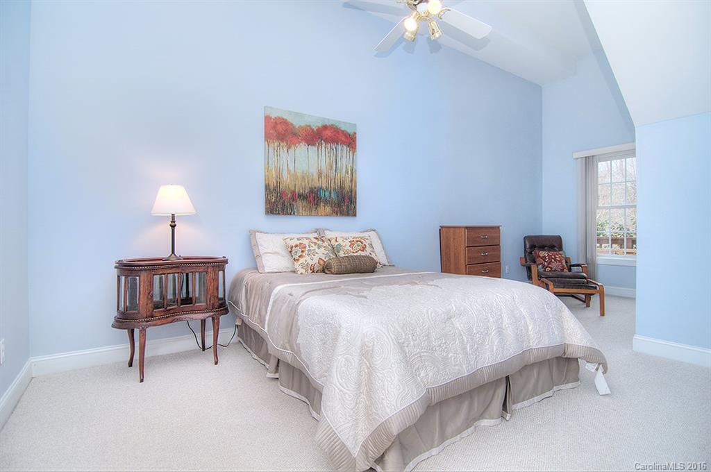 29023 Beaver Run Tega Cay, SC 29708 - Photo 16 of 24 a bedroom with bed and a chandelier