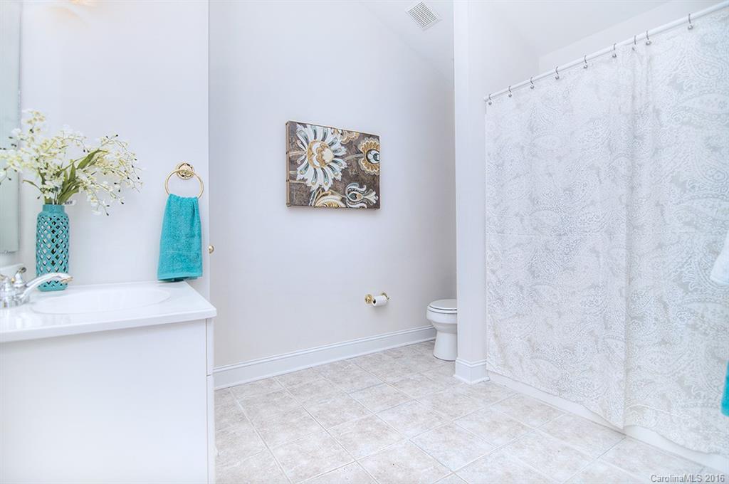 29023 Beaver Run Tega Cay, SC 29708 - Photo 17 of 24 a bathroom with a sink a toilet and a mirror