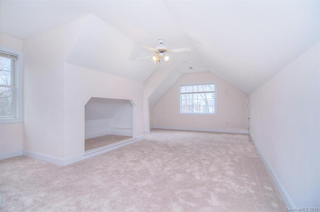 29023 Beaver Run Tega Cay, SC 29708 - Photo 19 of 24 an empty room with windows and ceiling fan