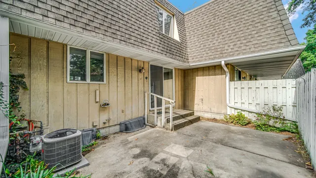a backyard of a house with outdoor seating and plants