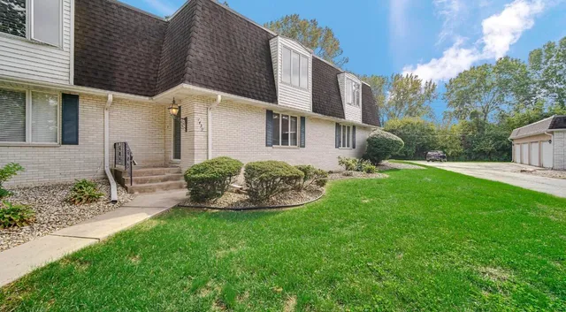 a front view of a house with garden and porch