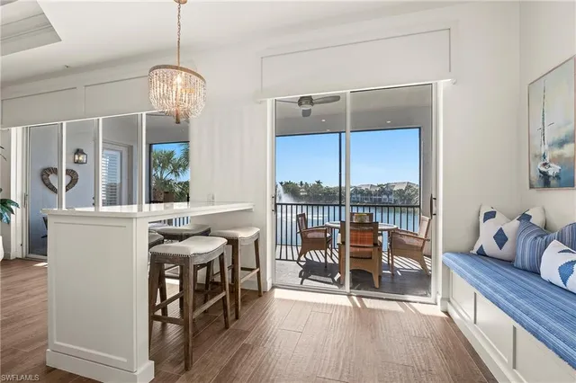 a very nice looking room with a large window and furniture