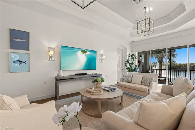 a living room with furniture a rug and a chandelier