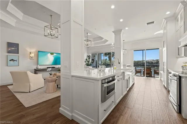 a kitchen with stainless steel appliances granite countertop a stove and a white cabinets