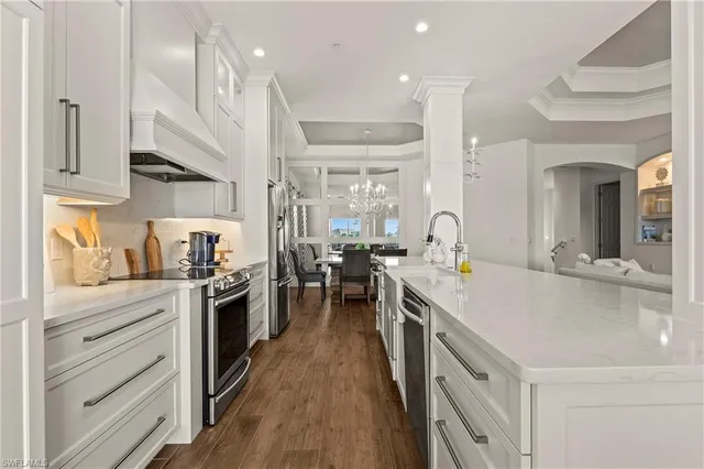 a kitchen with a sink stove and cabinets