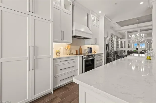 a kitchen with white cabinets and stainless steel appliances