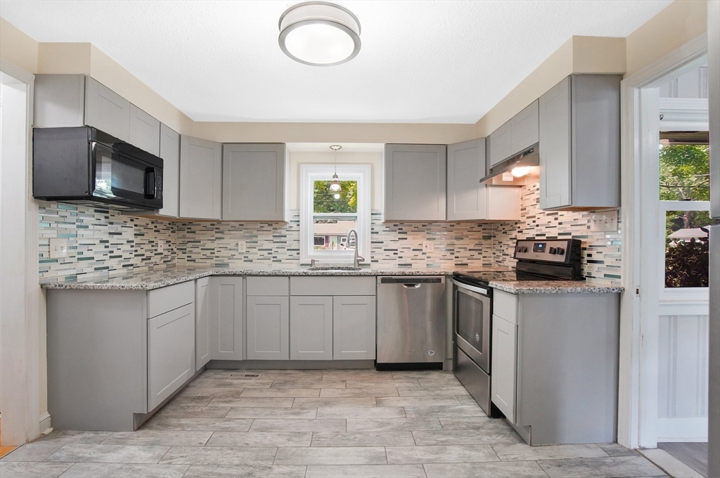 67 Jeffrey Road Springfield, MA 01119 - Photo 18 of 28 a kitchen with stainless steel appliances granite countertop a sink stove and microwave