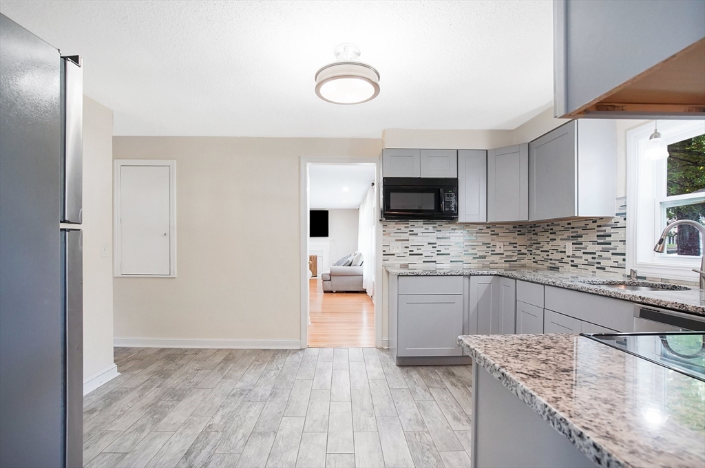 67 Jeffrey Road Springfield, MA 01119 - Photo 20 of 28 a kitchen with granite countertop a stove a sink and a refrigerator