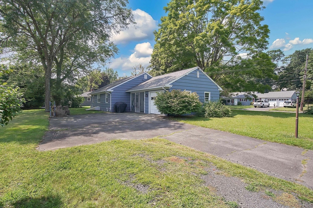 67 Jeffrey Road Springfield, MA 01119 - Photo 4 of 28 a front view of a house with a yard and garage
