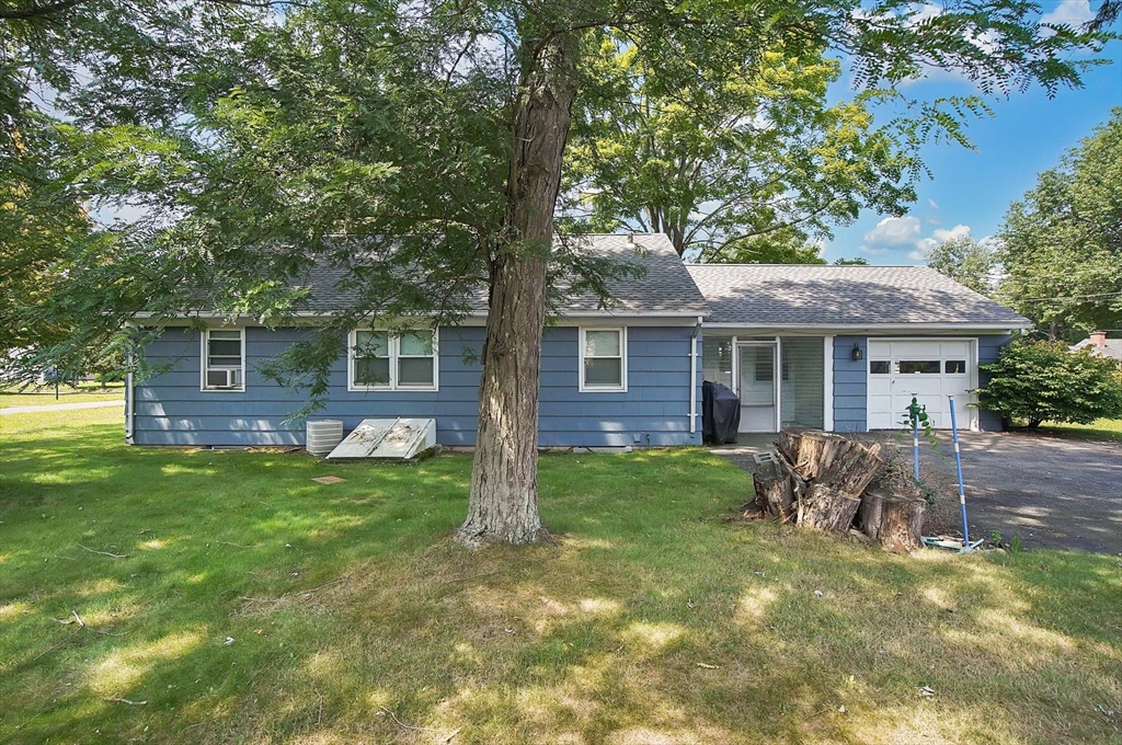 67 Jeffrey Road Springfield, MA 01119 - Photo 5 of 28 a backyard of a house with table and chairs potted plants and large tree