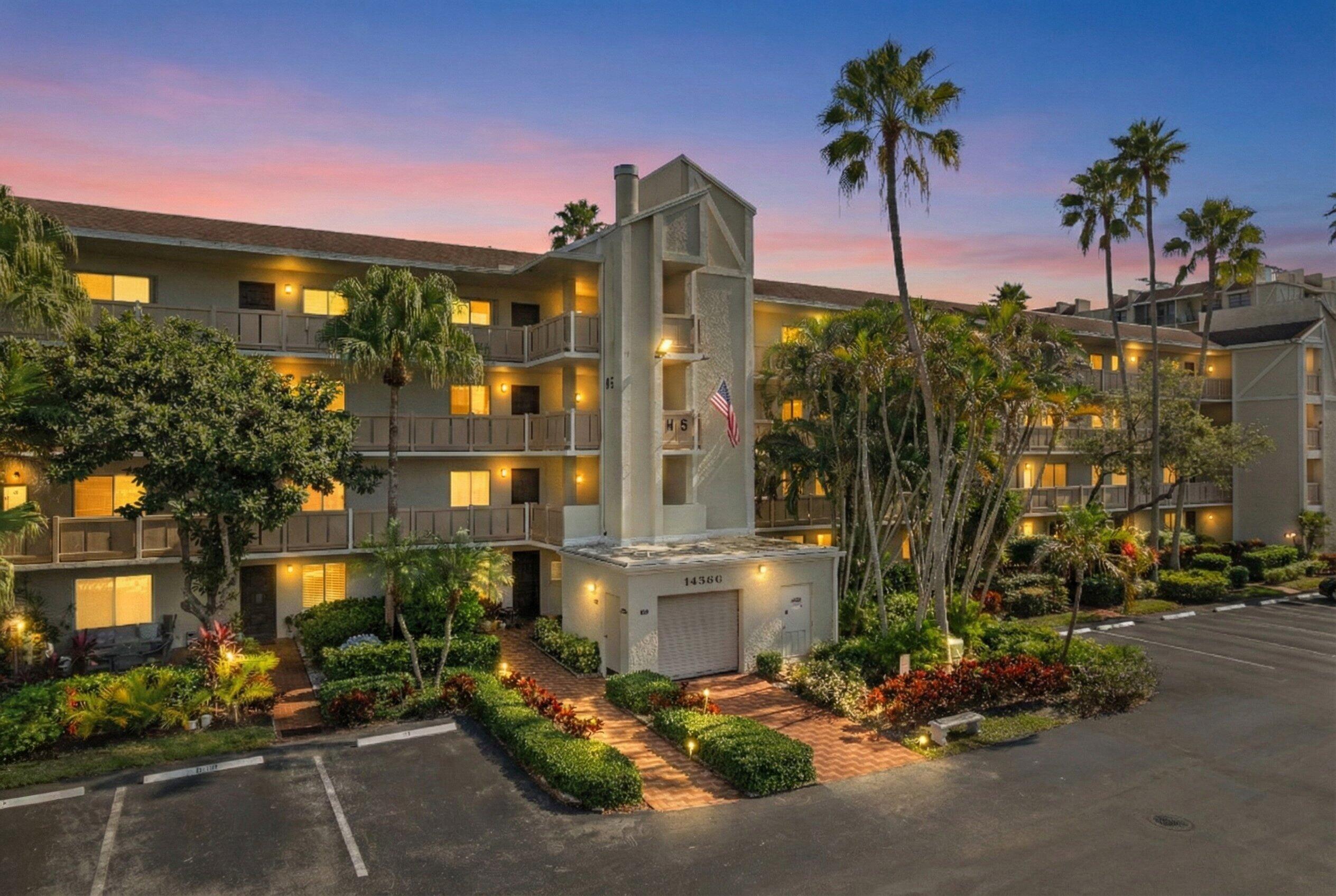 14360 Strathmore Lane, Unit 404 Delray Beach, FL 33446 - Photo 1 of 42 a front view of a building with palm trees