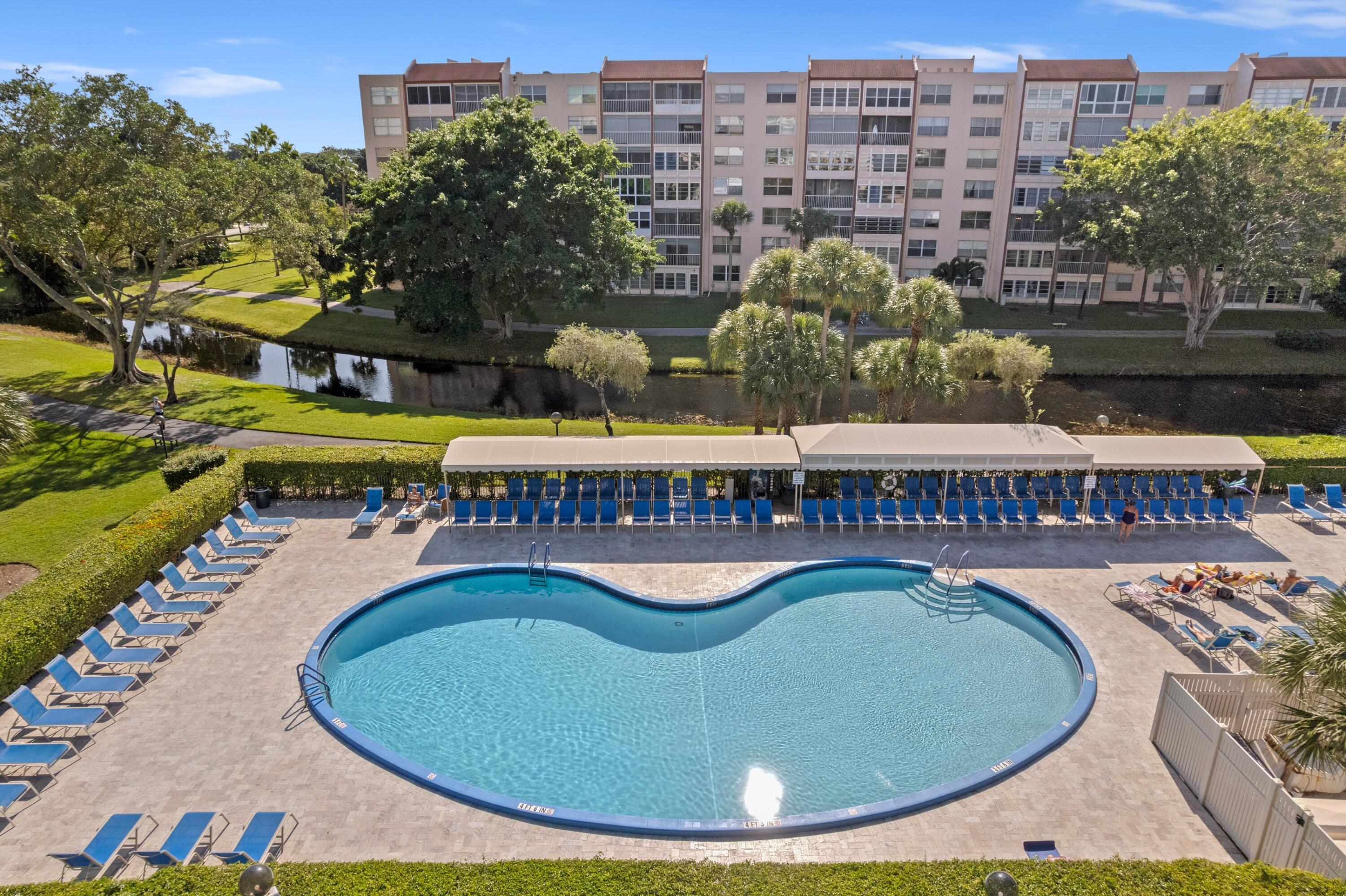 14360 Strathmore Lane, Unit 404 Delray Beach, FL 33446 - Photo 22 of 42 a view of a swimming pool with a patio
