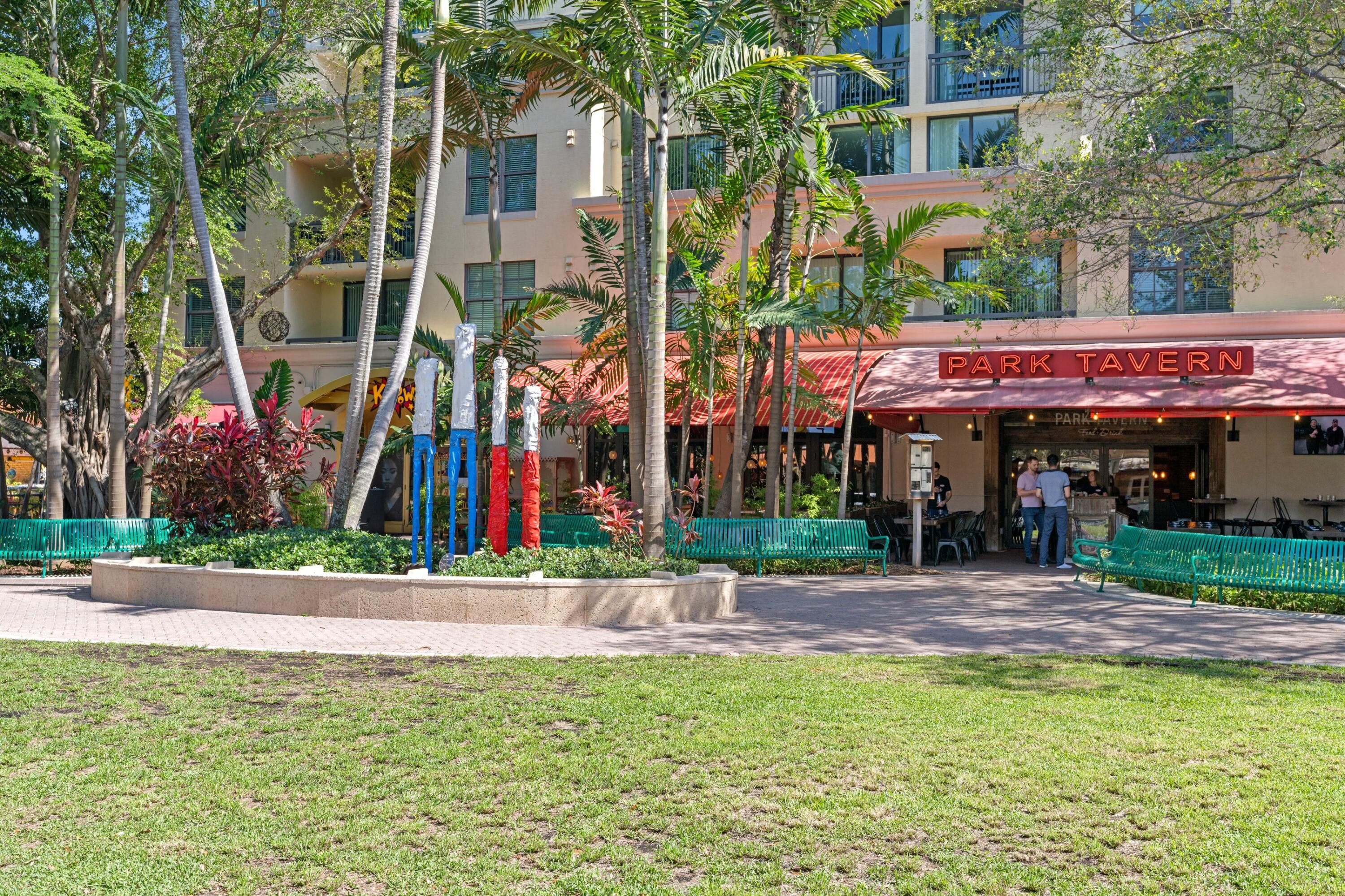 14360 Strathmore Lane, Unit 404 Delray Beach, FL 33446 - Photo 37 of 42 a view of a building with a yard and a palm tree
