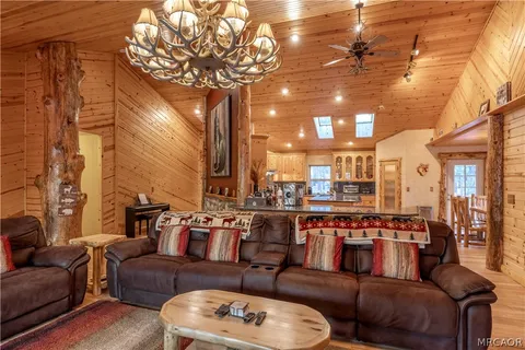 a living room with furniture and a chandelier
