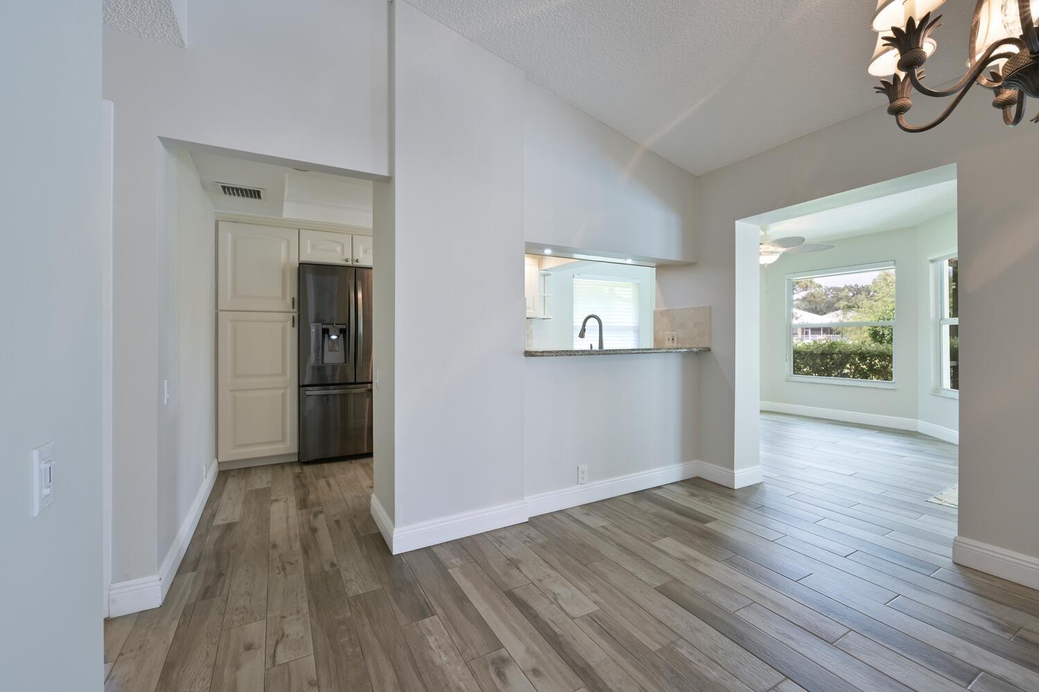 166 Bayberry Circle Jupiter, FL 33458 - Photo 13 of 37 wooden floor in an empty room with a window