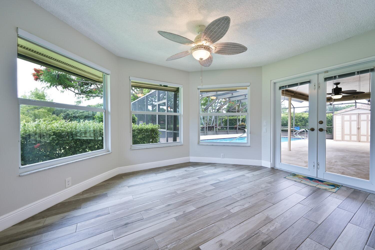 166 Bayberry Circle Jupiter, FL 33458 - Photo 14 of 37 a view of an empty room with wooden floor and a window