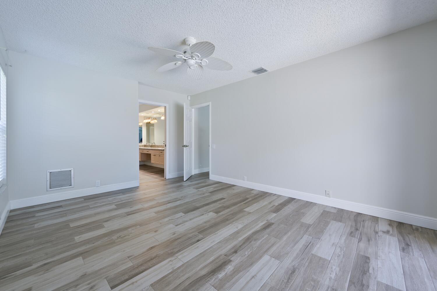 166 Bayberry Circle Jupiter, FL 33458 - Photo 18 of 37 a view of an empty room with wooden floor and closet