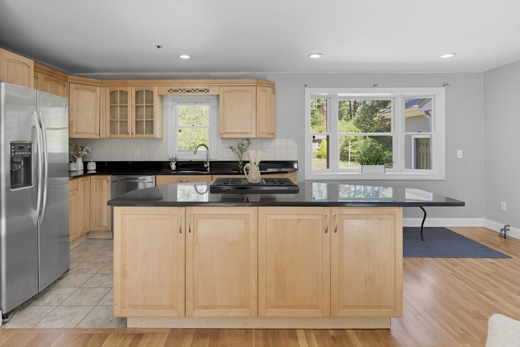 5 Charles Street Georgetown, MA 01833 - Photo 14 of 36 a kitchen with granite countertop a stove a sink and a refrigerator