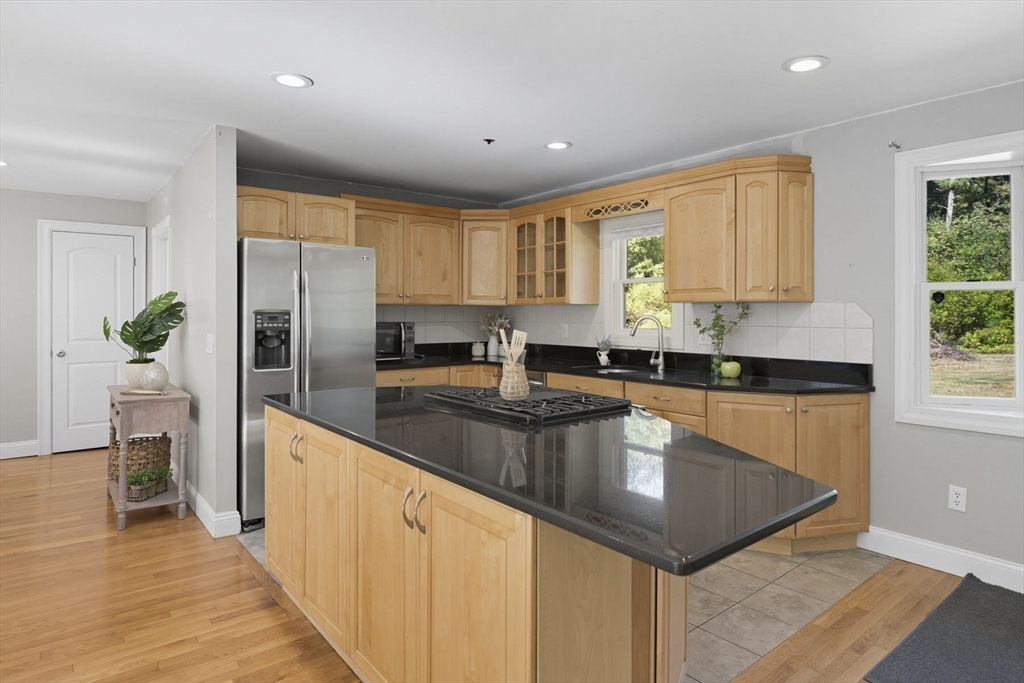 5 Charles Street Georgetown, MA 01833 - Photo 15 of 36 a kitchen with stainless steel appliances granite countertop a refrigerator a sink a stove a microwave and island