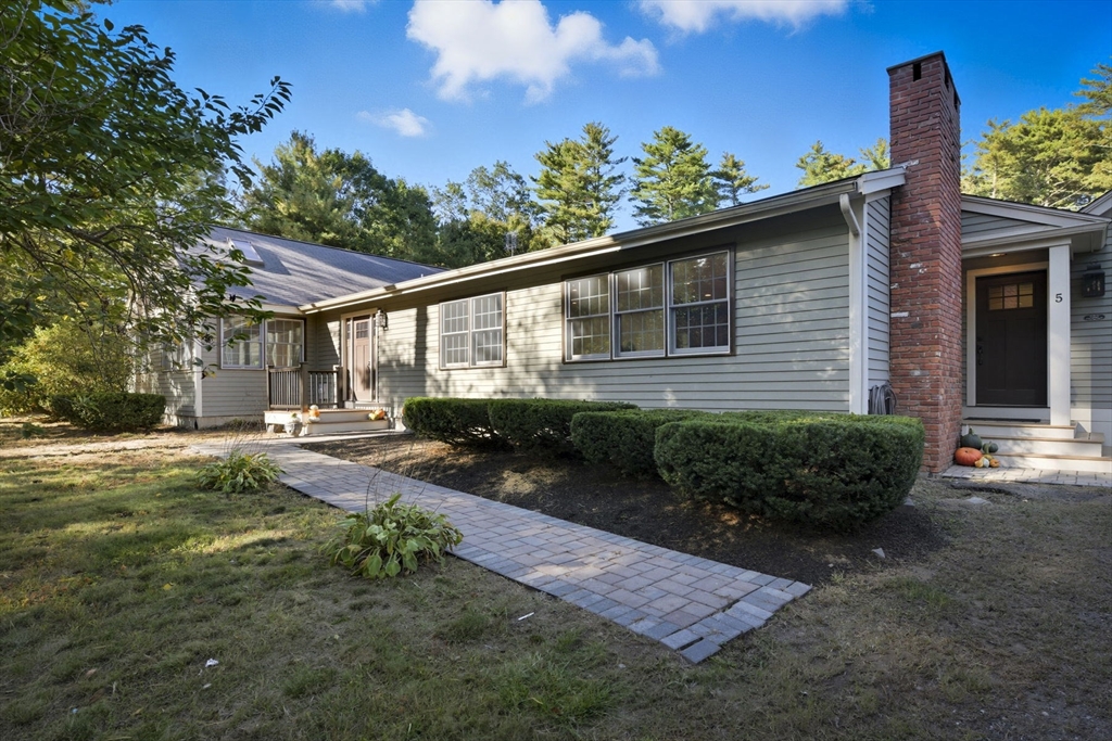 5 Charles Street Georgetown, MA 01833 - Photo 2 of 36 a front view of a house with garden