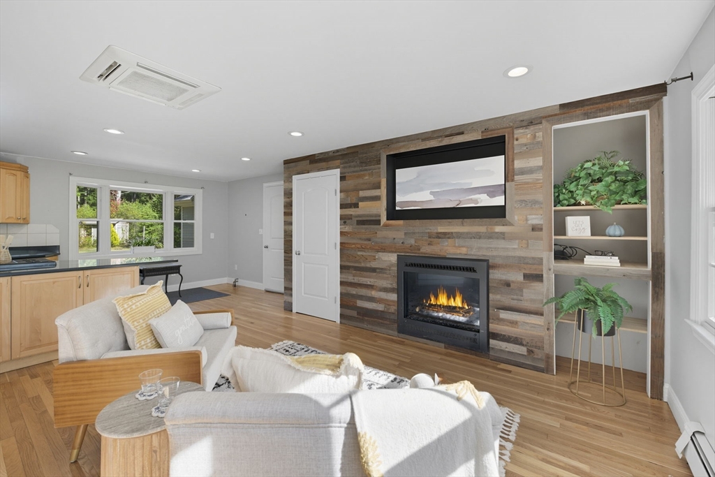 5 Charles Street Georgetown, MA 01833 - Photo 21 of 36 a living room with furniture a fireplace and a flat screen tv
