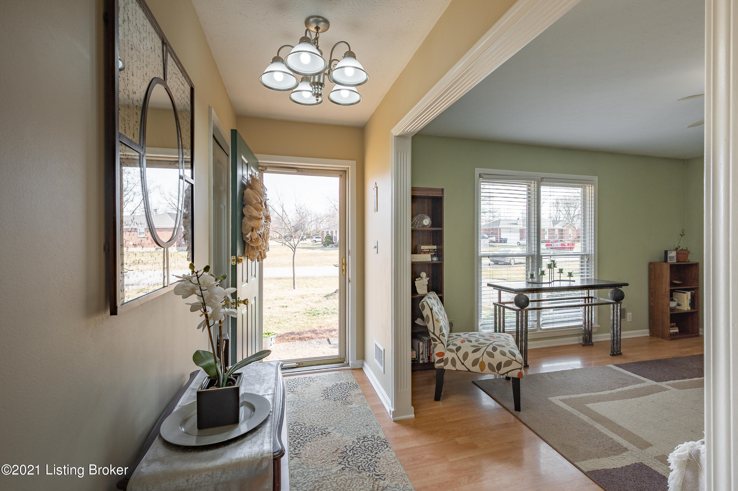 Immediately, you’ll notice the gorgeous laminate wood floors and the impressive light fixture brightening the entryway