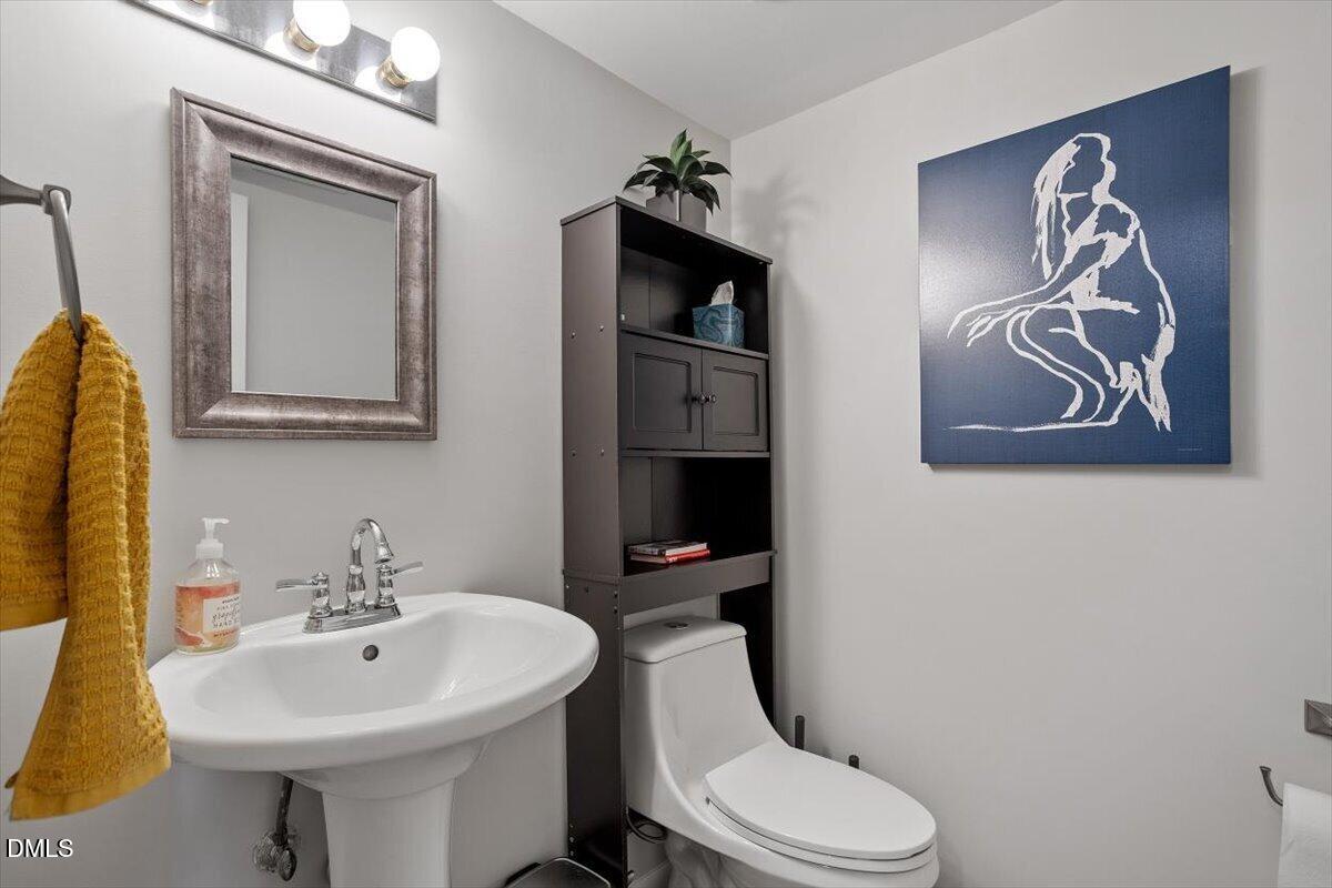 5045 Tall Pines Court Raleigh, NC 27609 - Photo 19 of 37 a white toilet sitting next to a bathroom sink
