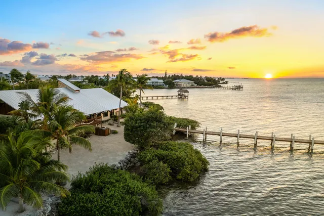 a view of a lake with a table and chairs