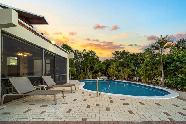 a living room with furniture and large windows