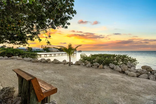 a view of a patio with table and chairs