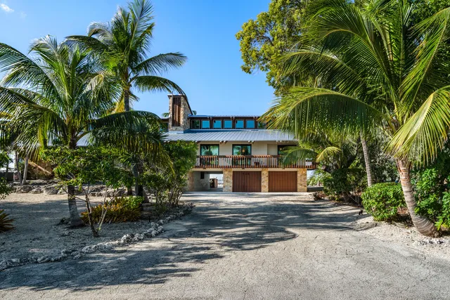 a view of a patio with table and chairs potted plants with wooden floor