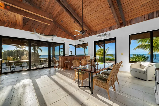 a view of a hallway with wooden floor and furniture