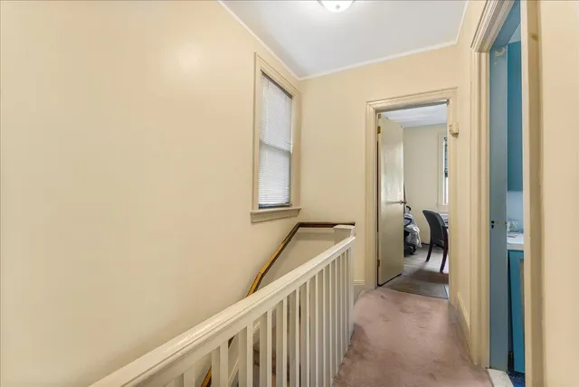 a view of a hallway with a bedroom and front door