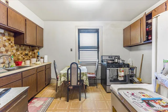 a view of kitchen with sink dining table and chairs