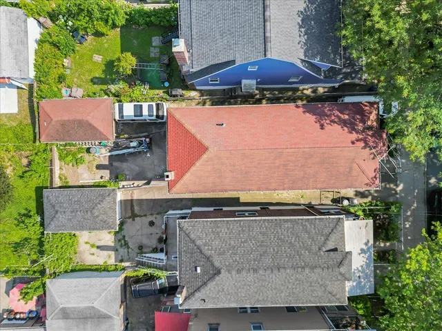 an aerial view of a house with yard and outdoor seating