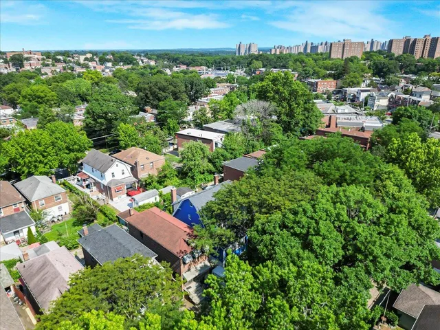 an aerial view of residential houses with outdoor space and street view
