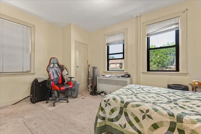 a bedroom with bed and a window