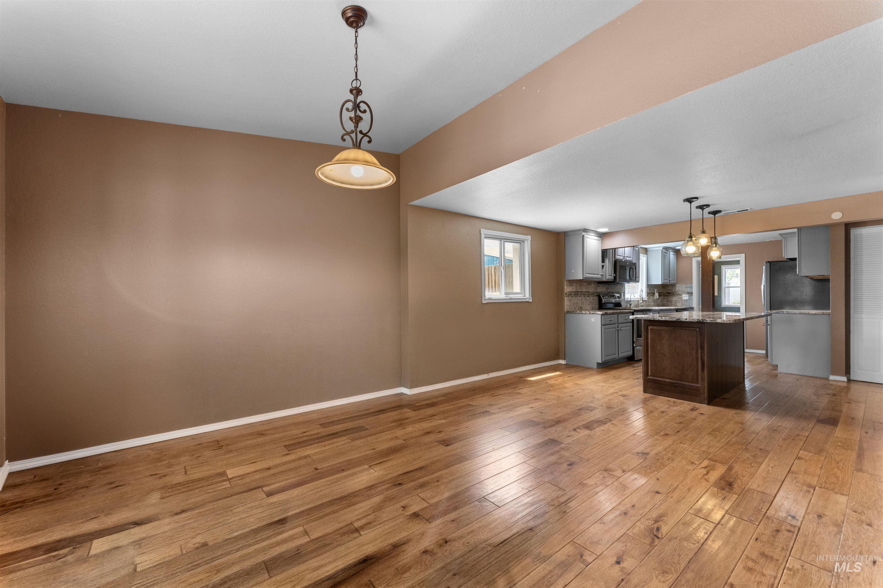 17441 Upper Pleasant Ridge Road Caldwell, ID 83607 - Photo 7 of 40 Open-concept living space featuring wood-finish flooring